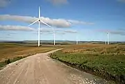 The towers of wind turbines support the rotors.