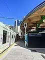 Anzac station entrance canopy during construction, with reopened Anzac Station tram stop, 2022.