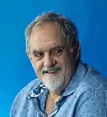 Head and shoulders images of Jon Landau looking to right of camera at 2022 press conference in Tokyo