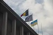 The Belgian, European Union and Ukrainian flags flying together in a governmental building in Brussels as a show of solidarity amid the Russian invasion of Ukraine in 2022.