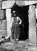 Kurdish girl standing in doorway.