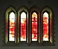 The Milllenium Window based on Revelation 22 v5. They need no light of lamp or sun, for the Lord God will be their light, and they will reign for ever and ever. "The sun sets on the city of Swansea but rises in the new Jerusalem"