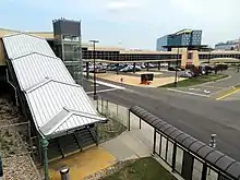 Staircase covered by canopy, with a footbridge behind