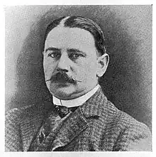 Black-and-white portrait photograph of a gentleman with moustache