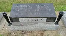 Small black granite stone inscribed with the names of Juckes and his wife, with their years of birth and death