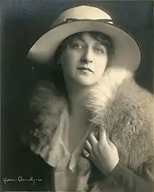 Portrait of a young white woman in 1921, wearing a hat with a wide brim and a fur stole.