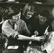 Fitzgerald shows her children paper dolls that her mother, Zelda, made for her. From the February 1959 Life Magazine issue by Robert Phillips.