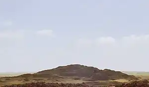 A photograph of the mound of sand that comprises the destroyed remains of the pyramid, called 'Merenre's beauty shines', which belonged to Merenre Nemtyemsaf I.