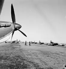 Propeller-driven aircraft dispersed along an unsealed airstrip