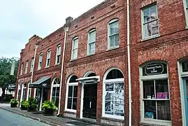 Immediately around the corner to the right, 310–312 West Congress Street, the frontages of the previous properties