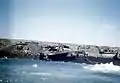 Damaged landing craft on beach, 1945
