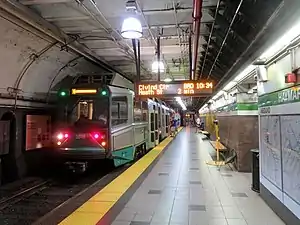 A light rail vehicle in a subway station with a low platform