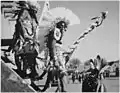 Three Pueblo Indians watching tourists at San Ildefonso Pueblo, New Mexico. Photograph taken by Ansel Adams in 1942.