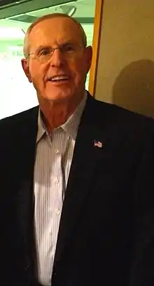 Tom Coughlin wearing a suit,