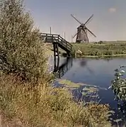 Vergezicht met molen en houten loopbrug - Sint Pancras